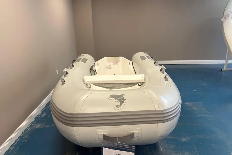 Slide: The Image of Inflatable Caribe L-10 boat, 2025 model, displayed indoors with wooden flooring. - 4