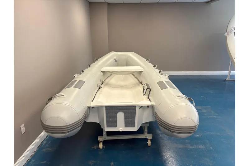 Slide: The Image of Inflatable Caribe L-10 boat, 2025 model, displayed indoors with wooden flooring and decorative plants. - 5