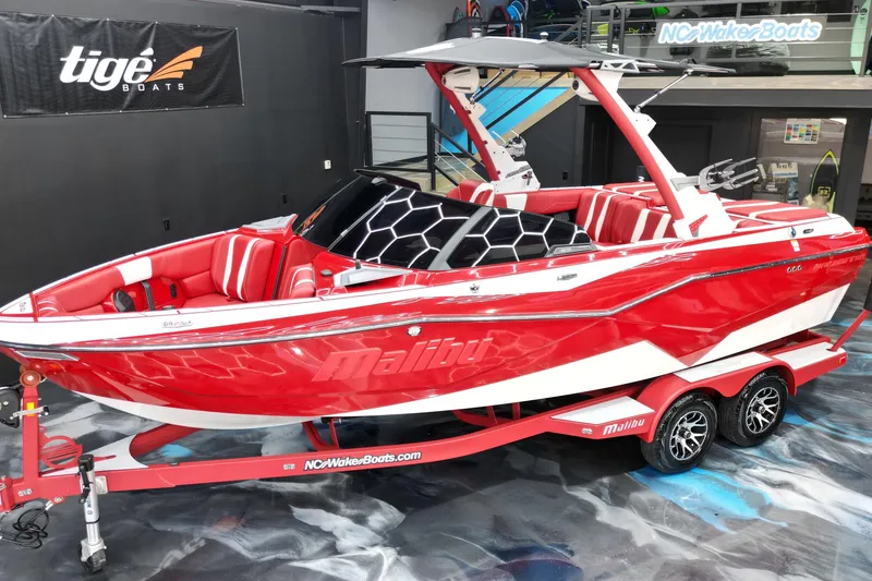 Slide: The Image of 2023 Malibu Wakesetter 22 LSV in vibrant red on display indoors. - 15