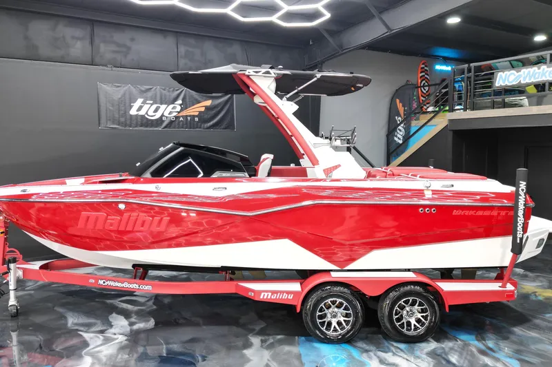 Slide: The Image of 2023 Malibu Wakesetter 22 LSV in vibrant red, displayed indoors on a trailer. - 2