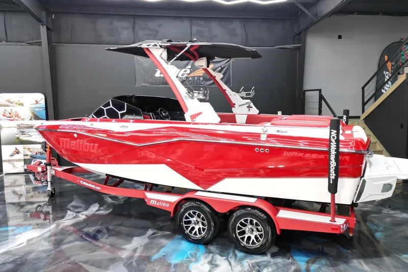 Slide: The Image of 2023 Malibu Wakesetter 22 LSV in showroom, vibrant red and white design. - 3