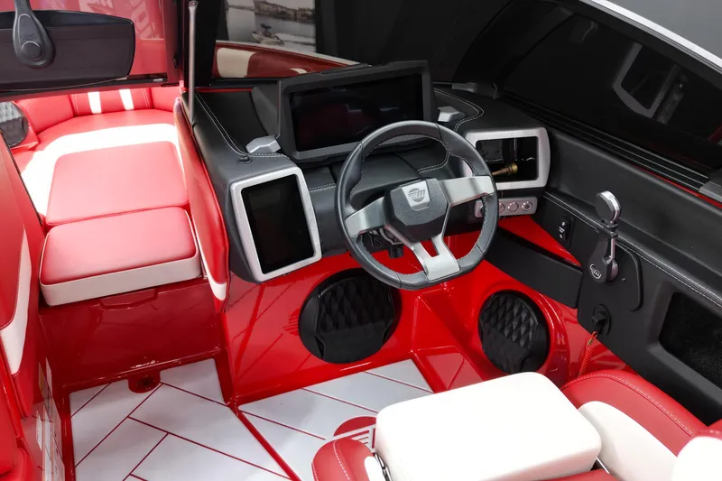 Slide: The Image of 2023 Malibu Wakesetter 22 LSV interior with red and white seating, modern dashboard, and steering wheel. - 7