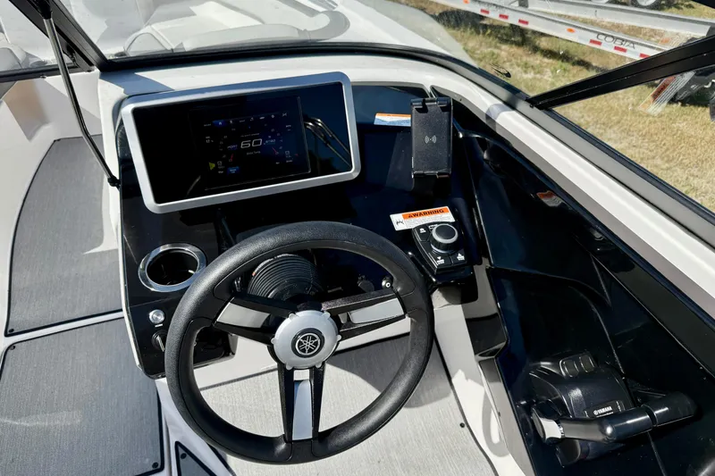 Slide: The Image of 2024 Yamaha Boats SX250 dashboard with steering wheel and digital display. - 14