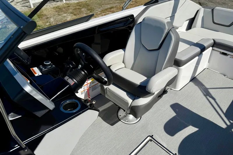 Slide: The Image of 2024 Yamaha Boats SX250 interior with captain's chair and steering console. - 22