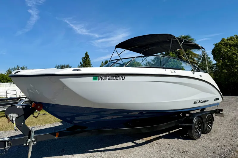 Slide: The Image of 2024 Yamaha Boats SX250 on trailer, sleek design under clear blue sky. - 3