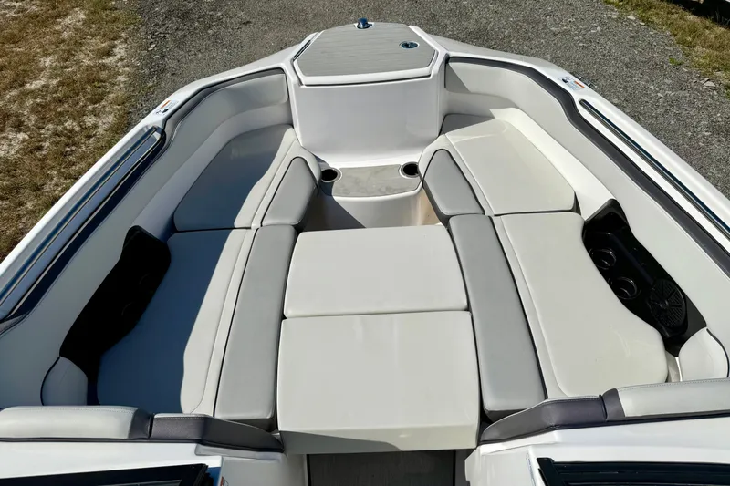 Slide: The Image of 2024 Yamaha Boats SX250 interior with spacious seating and cup holders. - 9