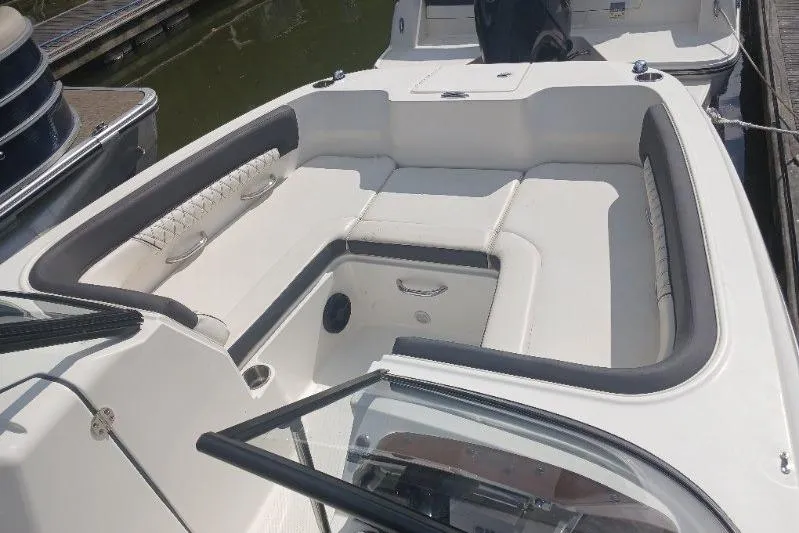 Slide: The Image of 2023 Bayliner DX 2200 boat interior with spacious seating and sleek design. - 8