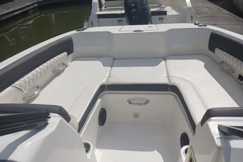 Slide: The Image of 2023 Bayliner DX 2200 boat interior with spacious seating and modern design. - 9