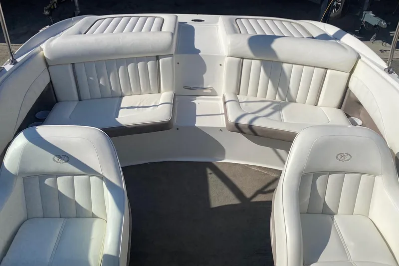 Slide: The Image of Interior of a 2004 Cobalt 220 boat with white leather seating. - 17