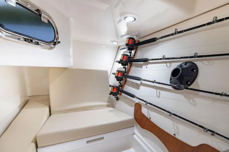 Slide: The Image of Interior of 2026 Pursuit DC 326 Dual Console boat, featuring storage and seating area. - 14