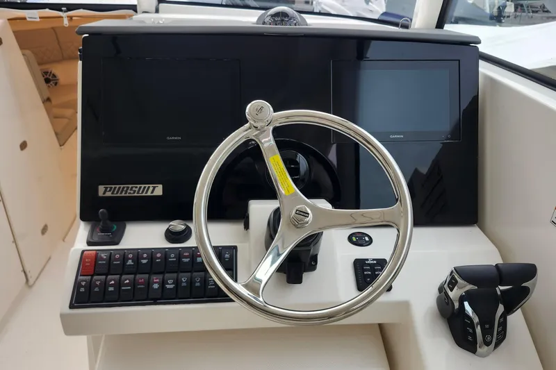 Slide: The Image of 2026 Pursuit DC 326 Dual Console helm with steering wheel and control panel. - 18