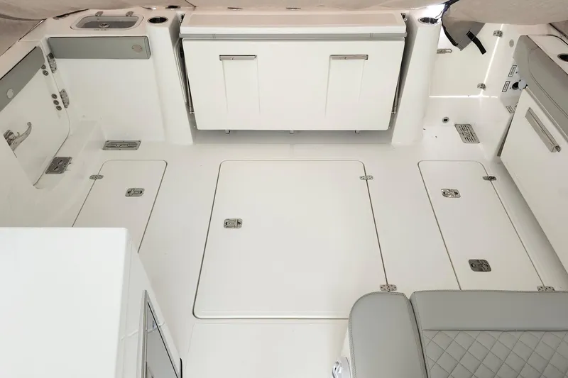 Slide: The Image of 2026 Pursuit DC 326 Dual Console boat interior with storage compartments and seating. - 22