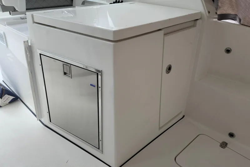 Slide: The Image of 2026 Pursuit DC 326 Dual Console boat interior with storage compartment. - 24