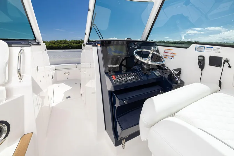 Slide: The Image of Manufacturer Provided Image: 2025 Pursuit DC 326 Dual Console boat interior with steering wheel and controls. - 42