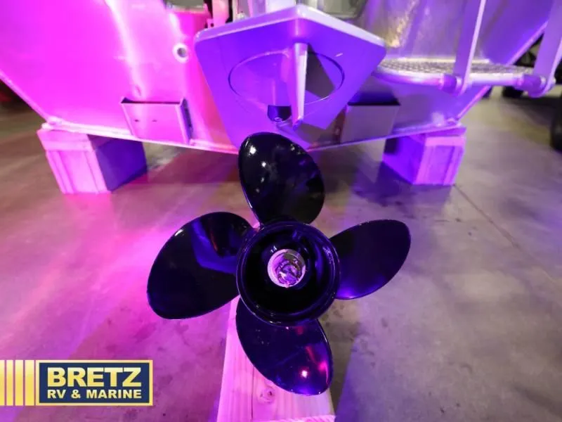 Slide: The Image of Hewscraft 160 Sportsman 2026 boat with propeller, purple lighting. - 11