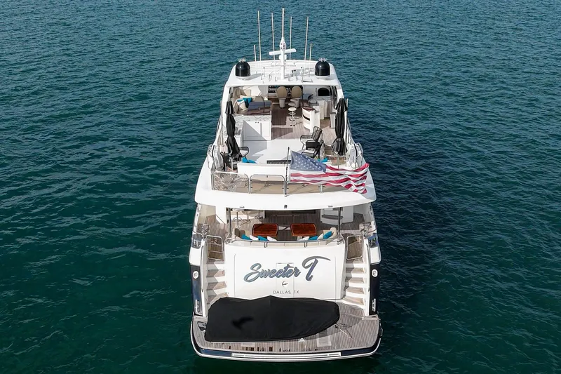 Slide: The Image of Princess 95 Motor Yacht 2011 on open water, rear view with American flag. - 15