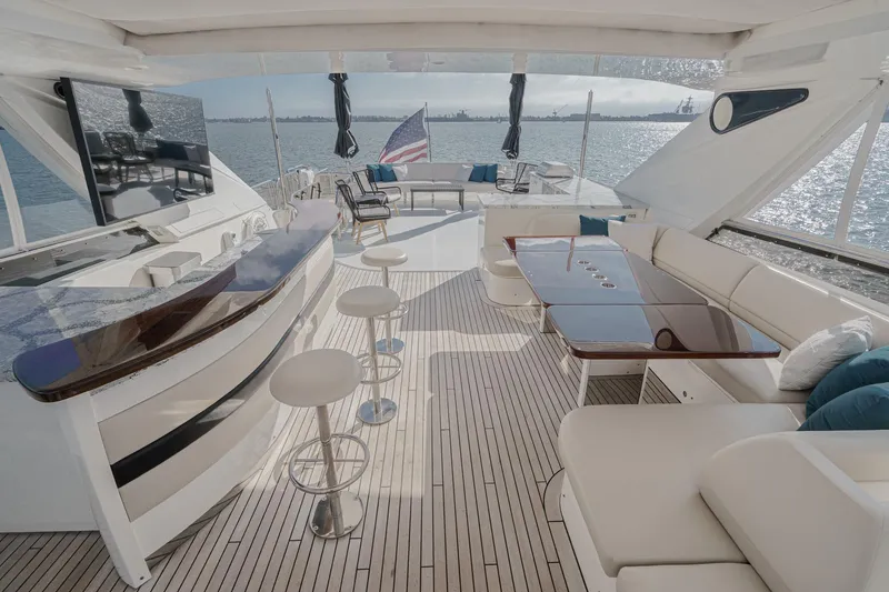 Slide: The Image of Luxurious 2011 Princess 95 Motor Yacht deck with seating, bar, and ocean view. - 25