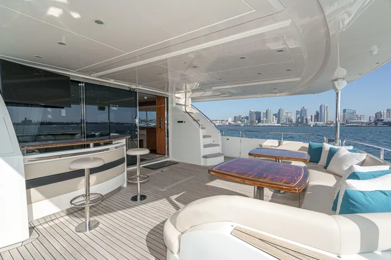 Slide: The Image of Luxurious 2011 Princess 95 Motor Yacht deck with bar, seating, and city skyline view. - 31