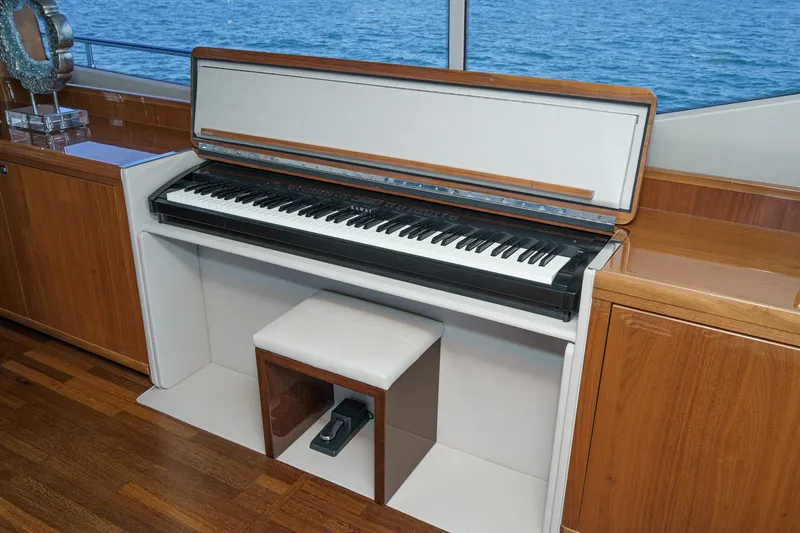 Slide: The Image of Luxury yacht interior with a Kawai piano, wooden cabinetry, and ocean view. Princess 95 Motor Yacht, 2011. - 40