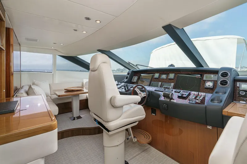 Slide: The Image of Luxurious 2011 Princess 95 Motor Yacht cockpit with modern navigation controls and plush seating. - 48