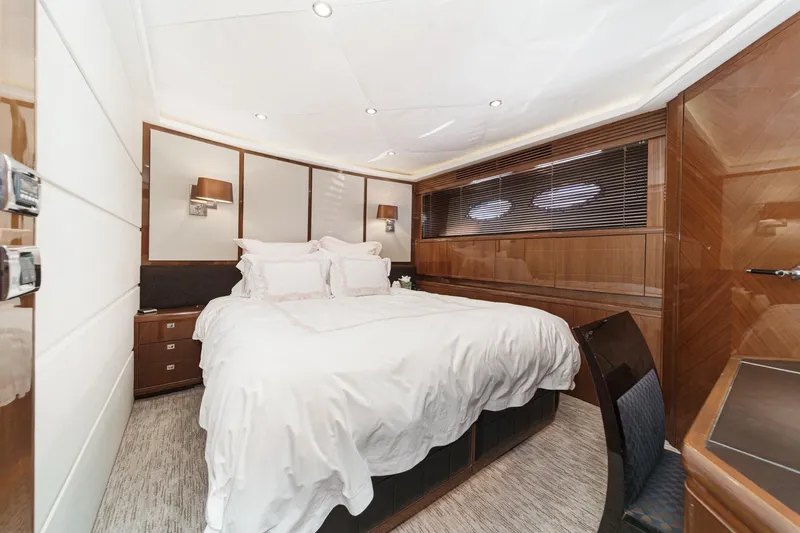 Slide: The Image of Luxurious bedroom interior of 2011 Princess 95 Motor Yacht with elegant wood paneling. - 55