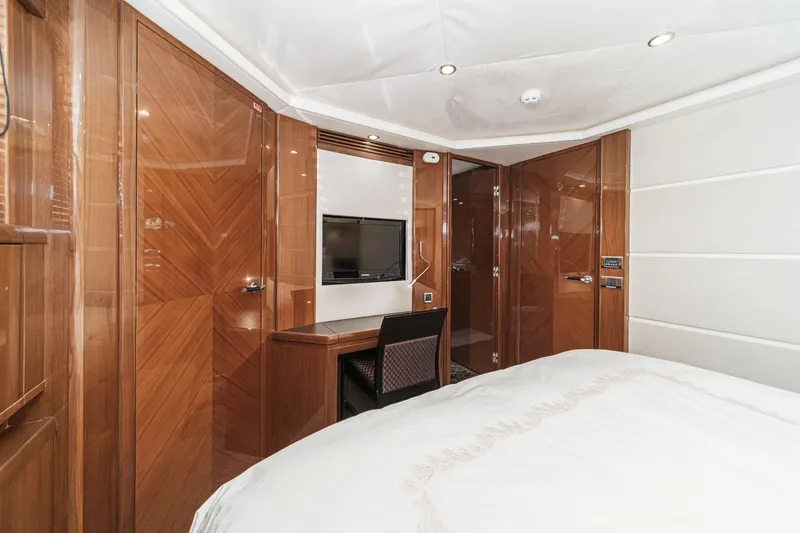 Slide: The Image of Luxurious cabin interior of 2011 Princess 95 Motor Yacht with wood paneling and TV. - 56