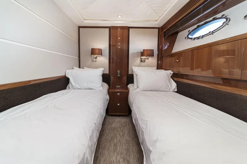 Slide: The Image of Luxurious twin cabin interior on 2011 Princess 95 Motor Yacht, featuring elegant wood paneling. - 58