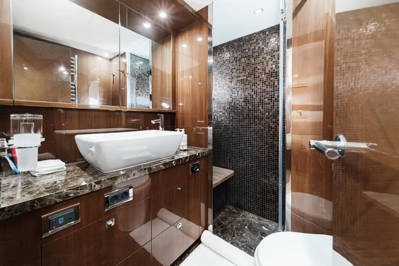 Slide: The Image of Luxurious bathroom on 2011 Princess 95 Motor Yacht with modern sink and elegant wood finishes. - 59