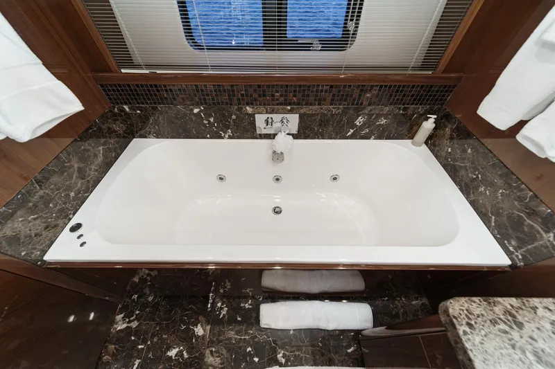 Slide: The Image of Luxurious bathtub in 2011 Princess 95 Motor Yacht with marble accents and ocean view. - 63