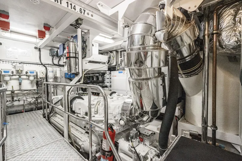 Slide: The Image of Engine room of a 2011 Princess 95 Motor Yacht, featuring polished metal components. - 74