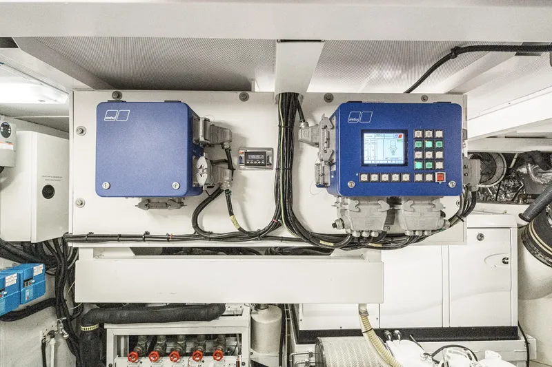 Slide: The Image of Engine room of 2011 Princess 95 Motor Yacht with control panels and wiring. - 76