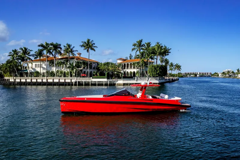 The Image of Red 2021 Wally 48 yacht cruising near luxury waterfront homes and palm trees. - 0