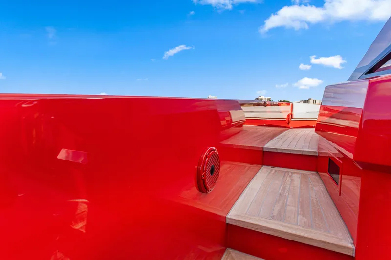 Slide: The Image of Red Wally 48 yacht deck with wooden steps, 2021 model, under clear blue sky. - 21
