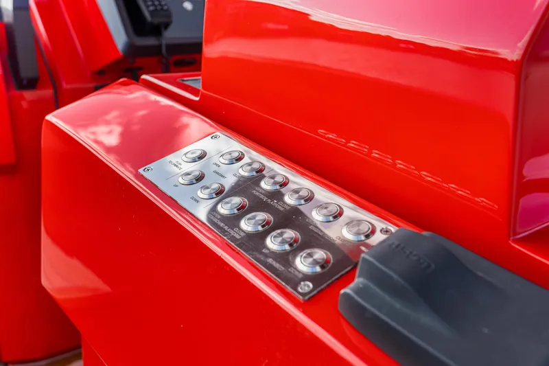 Slide: The Image of Control panel on a red 2021 Wally 48 yacht, featuring metallic buttons. - 22