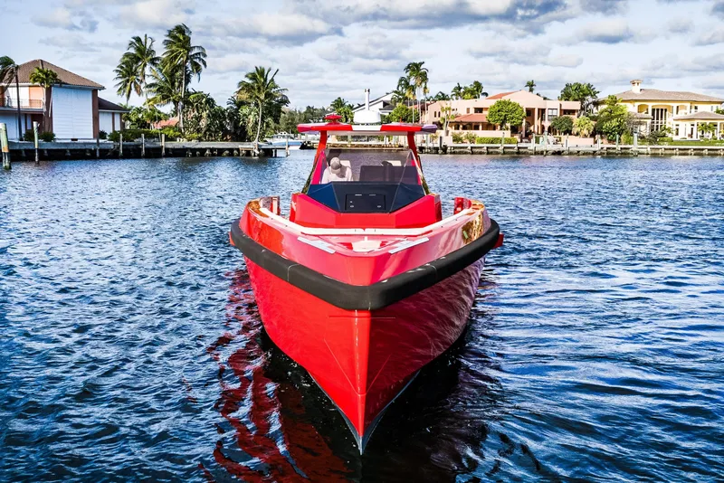 Slide: The Image of Red 2021 Wally 48 yacht on water, surrounded by palm trees and luxury homes. - 4