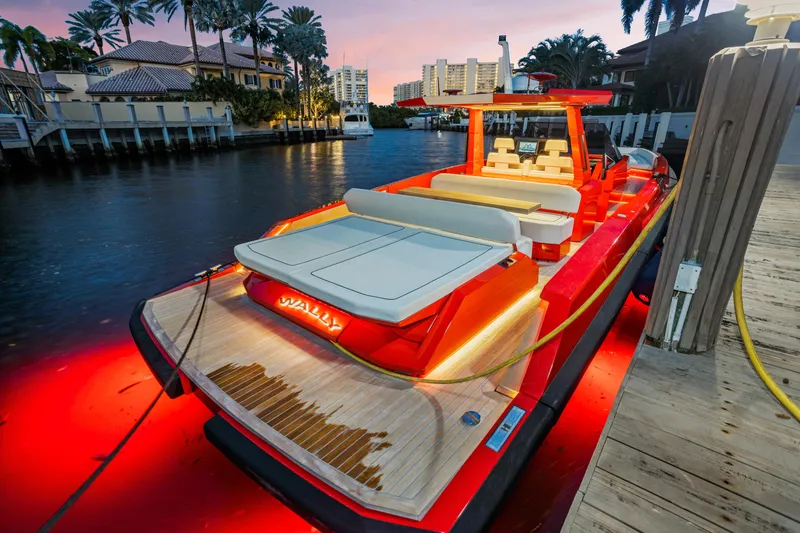 Slide: The Image of Luxury Wally 48 yacht docked at sunset, featuring sleek design and ambient lighting. - 41