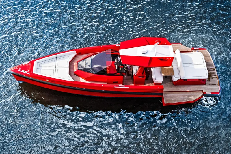 Slide: The Image of Red 2021 Wally 48 yacht on blue water, featuring sleek design and spacious deck. - 6