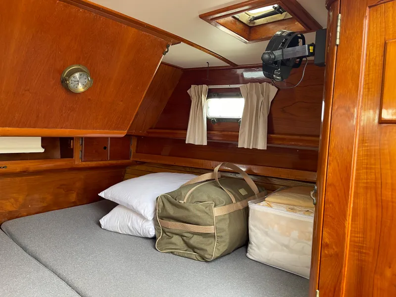 Slide: The Image of Cozy cabin interior of 1985 Chuck Paine Intrepid 40 sailboat with bed and luggage. - 17