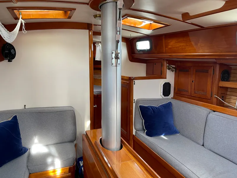 Slide: The Image of Interior of 1985 Chuck Paine Intrepid 40 yacht with cozy seating and wooden finishes. - 3
