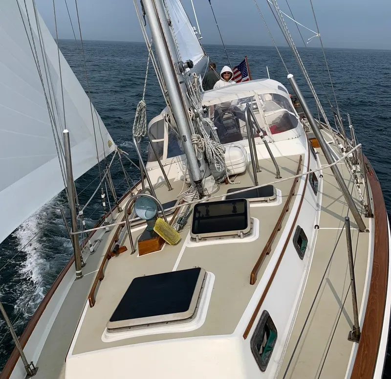 Slide: The Image of 1985 Chuck Paine Intrepid 40 Center Cockpit sailboat navigating open waters. - 33