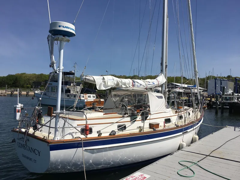 Slide: The Image of 1985 Chuck Paine Intrepid 40 Center Cockpit sailboat docked at marina. - 38