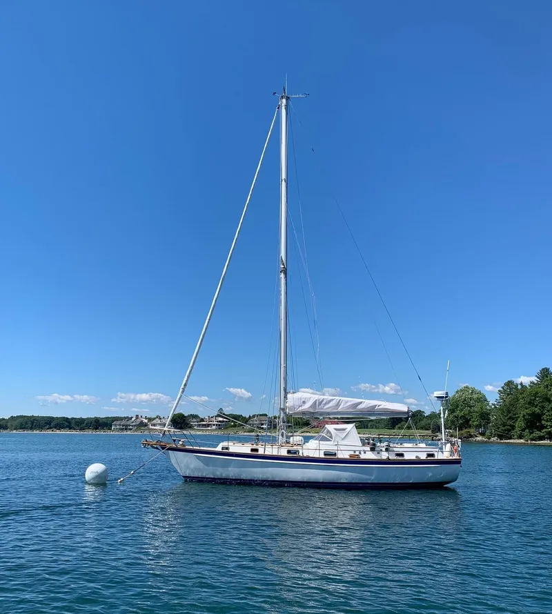 Slide: The Image of Sailboat "Intrepid 40 Center Cockpit" by Chuck Paine, 1985, on calm water under clear blue sky. - 41