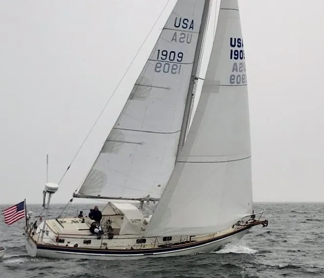 Slide: The Image of Sailing yacht Chuck Paine Intrepid 40 Center Cockpit, 1985, on open water with USA flag. - 42