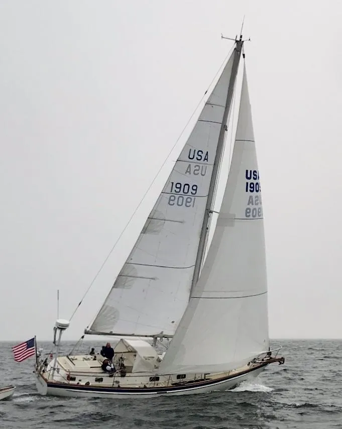 Slide: The Image of Sailing yacht Chuck Paine Intrepid 40 Center Cockpit, 1985, on open water with American flag. - 43
