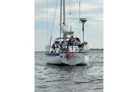 Slide: The Image of 1985 Chuck Paine Intrepid 40 Center Cockpit sailboat on calm waters, rear view. - 44