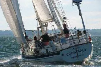 Slide: The Image of 1985 Chuck Paine Intrepid 40 Center Cockpit sailboat navigating open waters. - 45