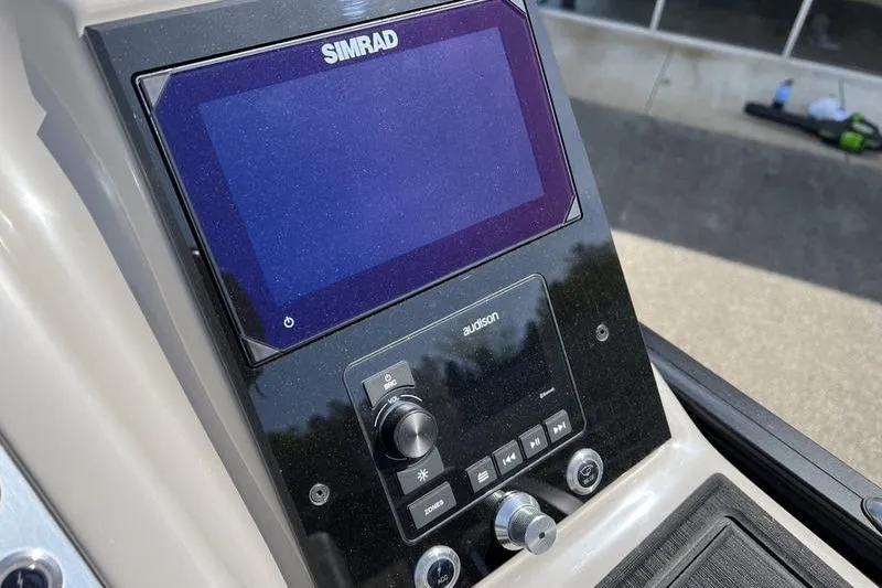 Slide: The Image of 2024 Barletta Corsa 23U dashboard featuring Simrad and Audison controls. - 17