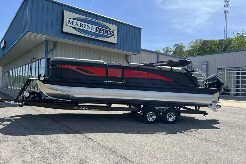 Slide: The Image of 2024 Barletta Corsa 23U pontoon boat on trailer at Marine Sales dealership. - 2