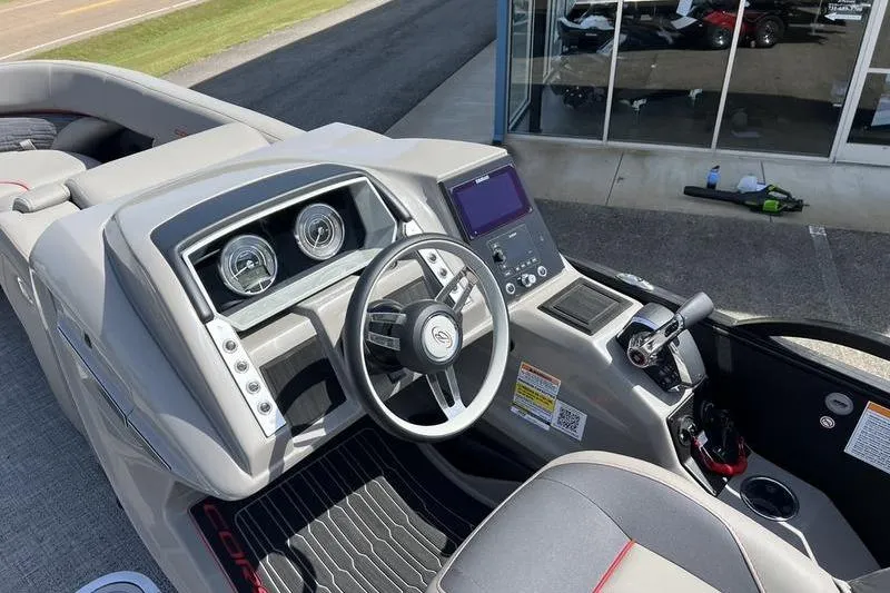 Slide: The Image of 2024 Barletta Corsa 23U boat dashboard with steering wheel and control panel. - 20