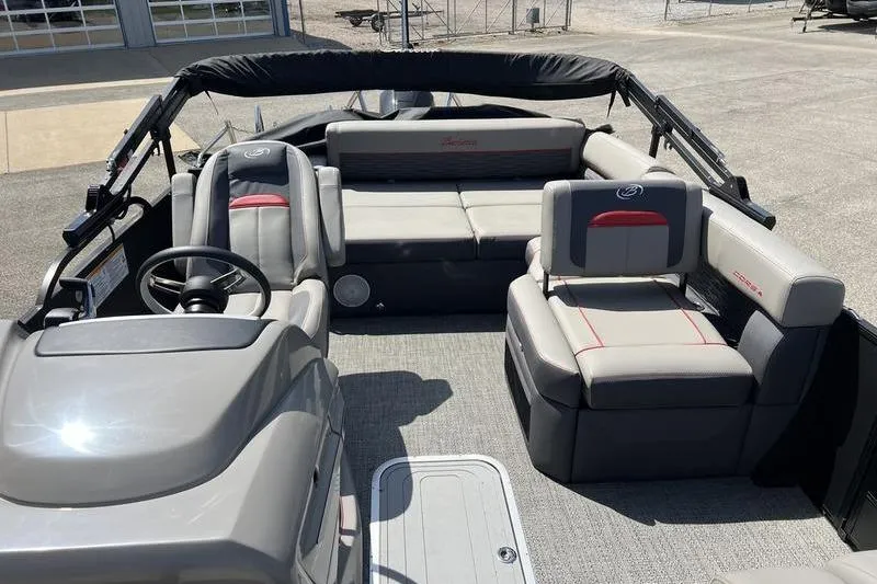 Slide: The Image of 2024 Barletta Corsa 23U pontoon boat interior with plush seating and steering console. - 22